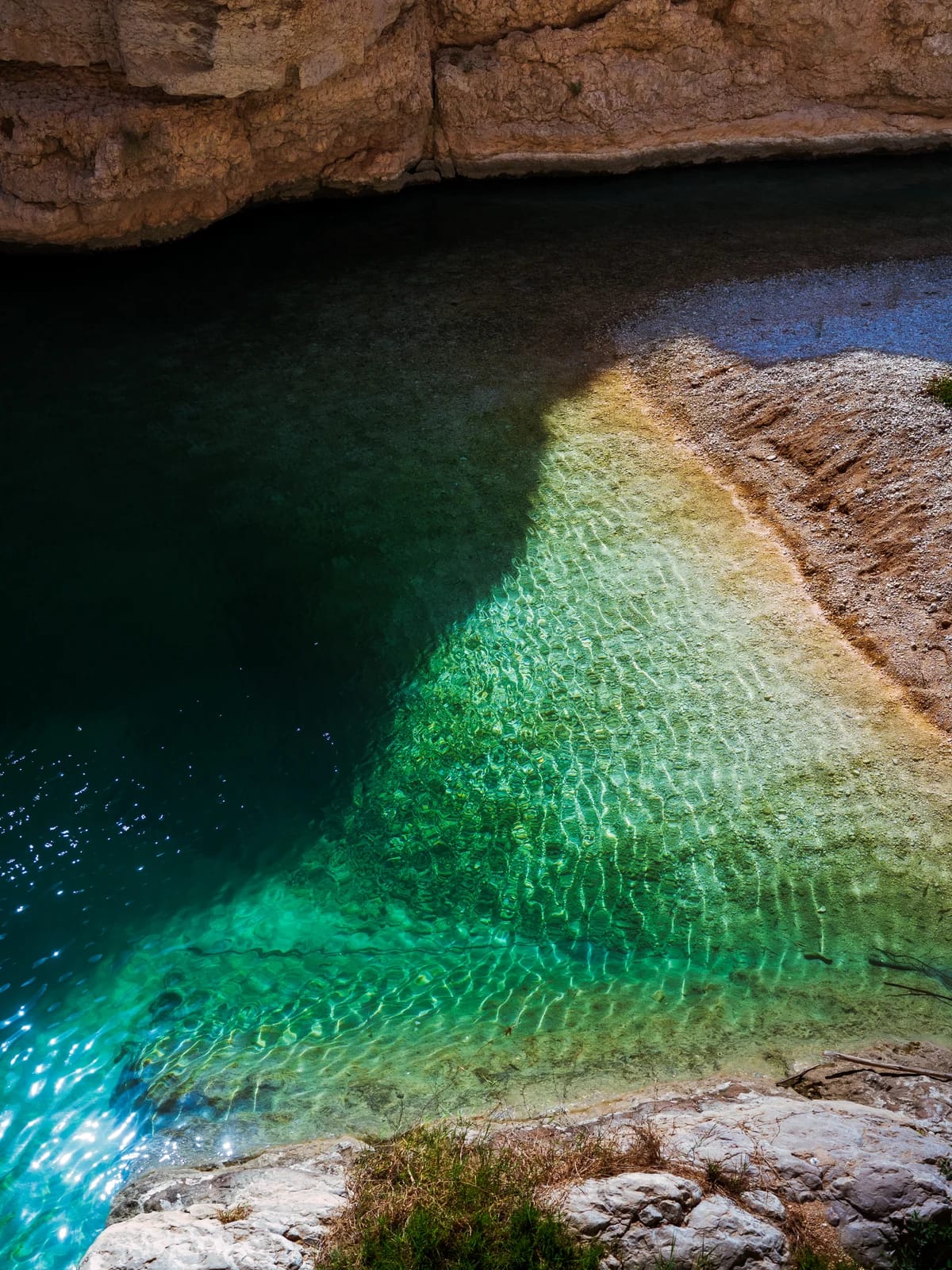 Turquoise water pool between the canyon walls of Wadi Shab